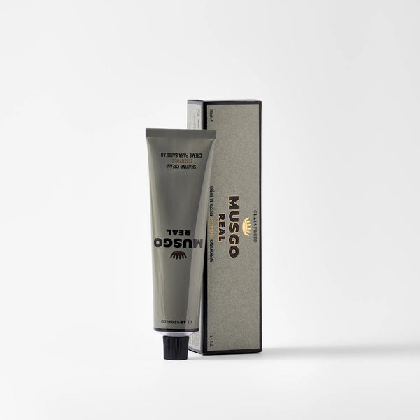 A gray tube of Claus Porto Musgo Real Shaving Cream Essentials by Claus Porto 1887 stands upright in front of its matching rectangular box, both displayed on a plain white background.