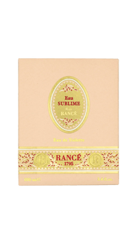 A beige box of Rancé Sublime Eau de Parfum by Rancé, adorned with gold and red accents and “Eau de Parfum” plus “100 mL / 3.4 fl. oz.” at the bottom—a luxurious floral fragrance.
