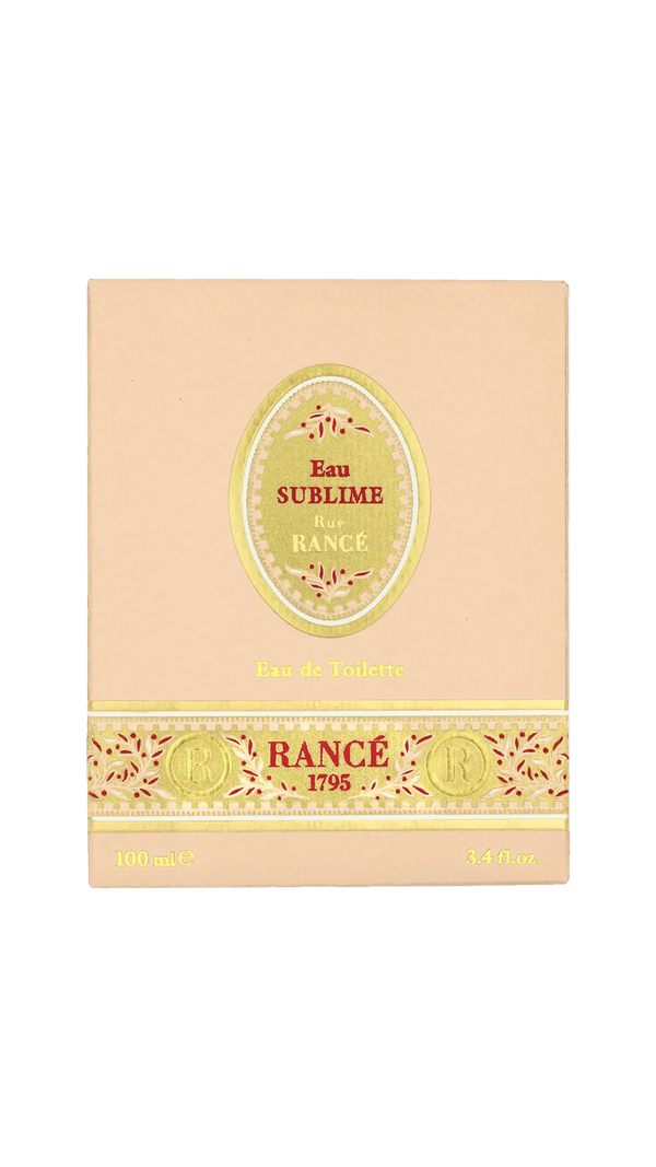 A beige box of Rancé Sublime Eau de Parfum by Rancé, adorned with gold and red accents and “Eau de Parfum” plus “100 mL / 3.4 fl. oz.” at the bottom—a luxurious floral fragrance.