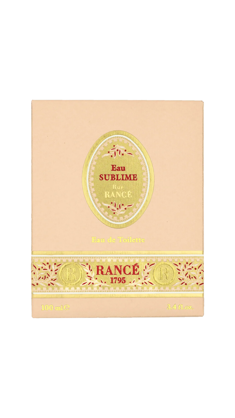 A beige box of Rancé Sublime Eau de Parfum by Rancé, adorned with gold and red accents and “Eau de Parfum” plus “100 mL / 3.4 fl. oz.” at the bottom—a luxurious floral fragrance.