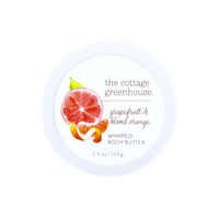 The Cottage Greenhouse Grapefruit & Blood Orange Body Butter by Margot Elena comes in a round white 5.5 oz container with watercolor citrus art on the lid, emphasizing this natural, moisturizing formula.