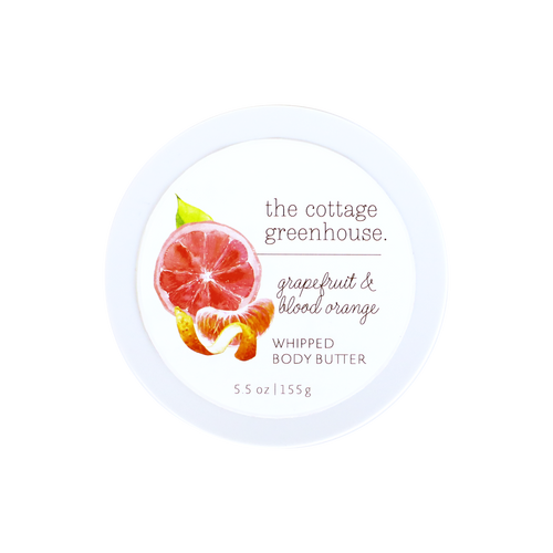 The Cottage Greenhouse Grapefruit & Blood Orange Body Butter by Margot Elena comes in a round white 5.5 oz container with watercolor citrus art on the lid, emphasizing this natural, moisturizing formula.