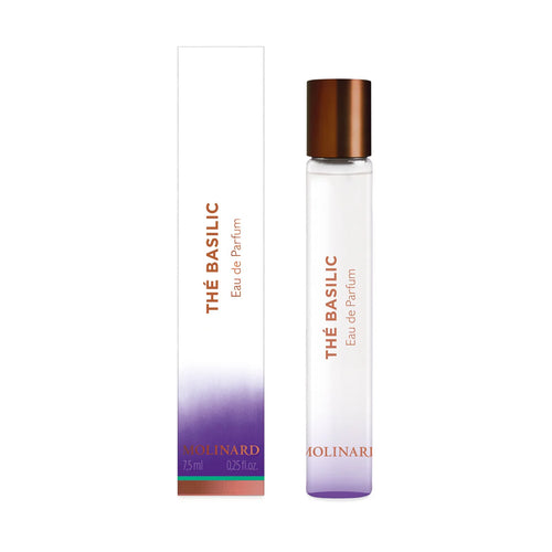 A clear Molinard Thé Basilic Eau de Parfum Roll-On stands next to its white, purple, and copper-accented box. Both feature the perfume name and Molinard brand in orange text, highlighting this fresh basil scent.