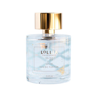 A clear glass perfume bottle labeled "Lolia Wish Parfum Bundle" by Fast Bundle, with gold accents, a shiny gold cap, and containing light blue liquid.