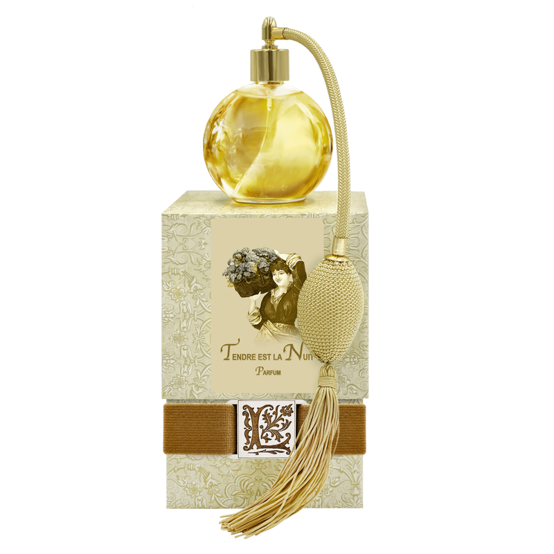 A vintage La Bouquetiere Tendre est la Nuit French Perfume bottle with a tassel and an ornate box featuring jasmine, primrose, and ylang-ylang designs, along with an image of a woman.