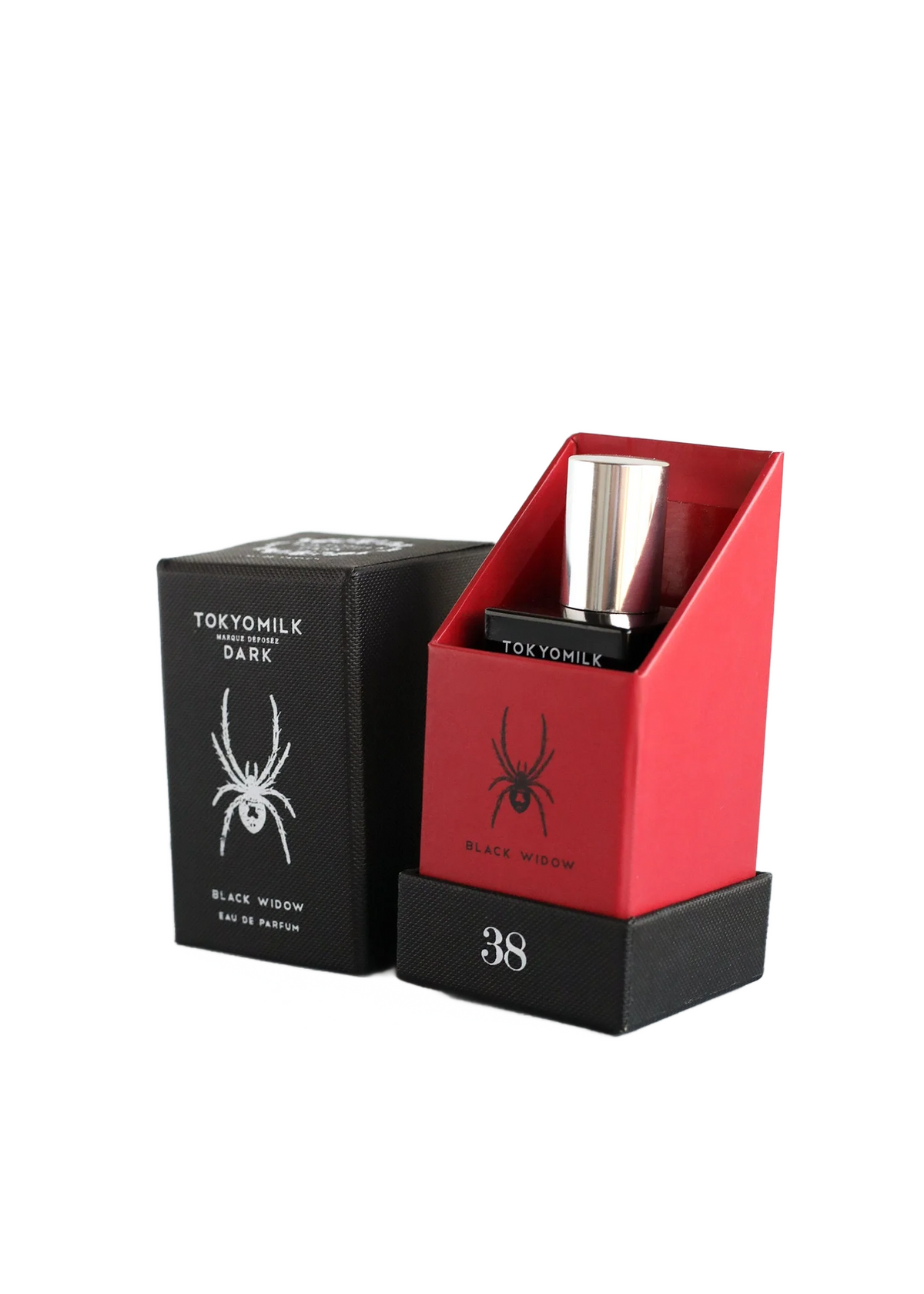 A bottle of Margot Elena TokyoMilk Dark Black Widow No. 38 Eau de Parfum in a red holder beside its black box, featuring spider graphics.