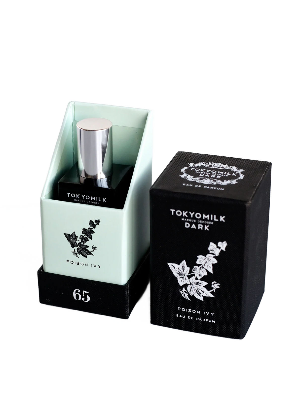 Bottle of "Margot Elena TokyoMilk Dark Poison Ivy No. 65 Eau de Parfum" perfume in a pale green container with a metallic cap, placed next to its black packaging box adorned with white floral and orris root graphics