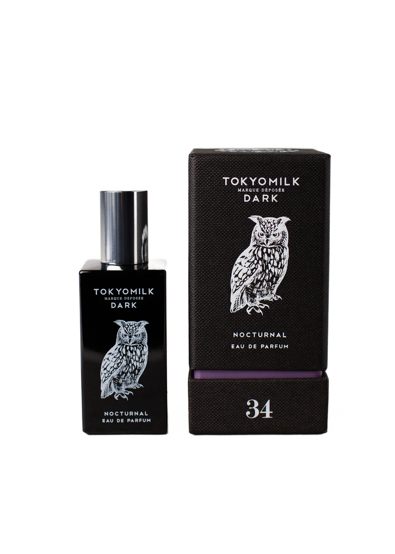 A bottle of Margot Elena TokyoMilk Dark Nocturnal No. 34 Eau de Parfum next to its packaging box, both adorned with a white owl graphic, on a white background.