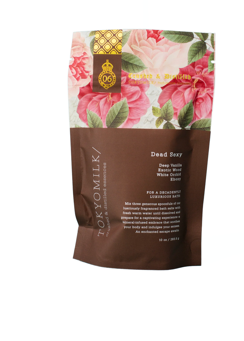 A package of Margot Elena TokyoMilk Dead Sexy Salt Soak featuring exfoliating sea salt and luxurious indulgence with floral designs and gold accents on a brown background. Details include product benefits and ingredients.