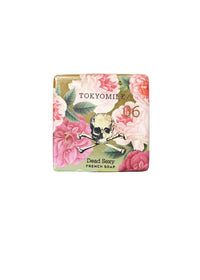 The TokyoMilk Dead Sexy Square Soap by Margot Elena is a triple-milled French soap with pink flower and gold skull crossbones packaging—an elegant shea butter bar for a luxurious cleanse.