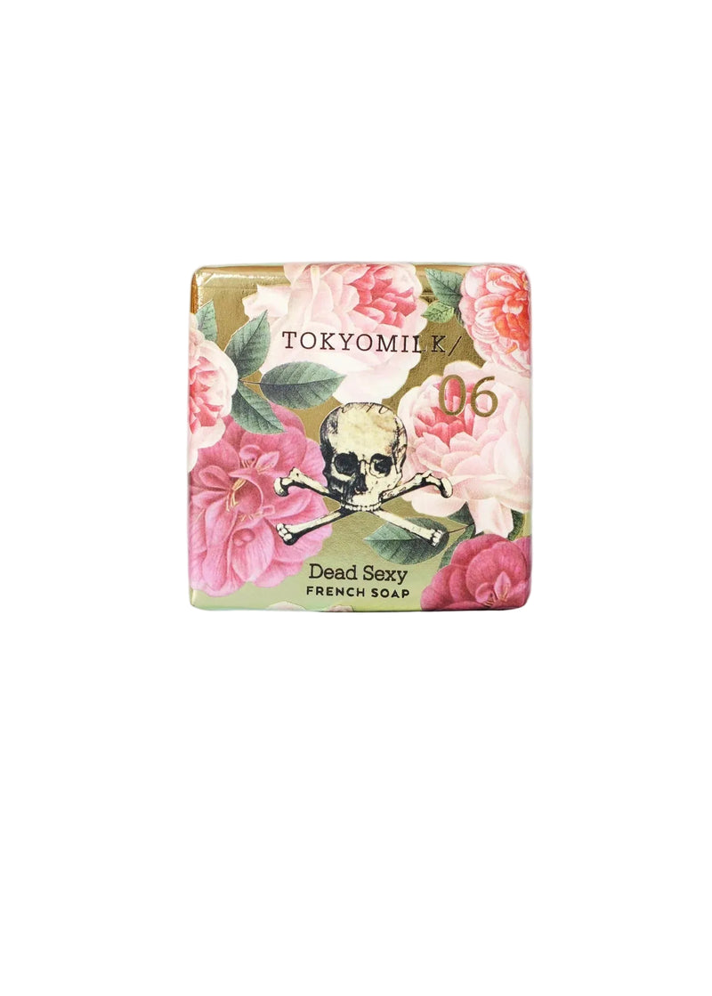 The TokyoMilk Dead Sexy Square Soap by Margot Elena is a triple-milled French soap with pink flower and gold skull crossbones packaging—an elegant shea butter bar for a luxurious cleanse.
