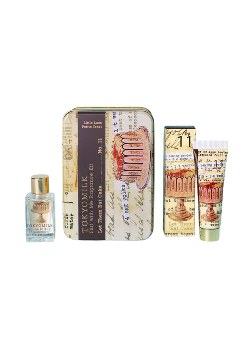 The TokyoMilk Let Them Eat Cake Flirt With Me Kit by Margot Elena comes in a tin with French vintage designs and a cake illustration, containing a perfume bottle, hand cream tube, and another small tube. The tin features the text "Let Them Eat Cake.