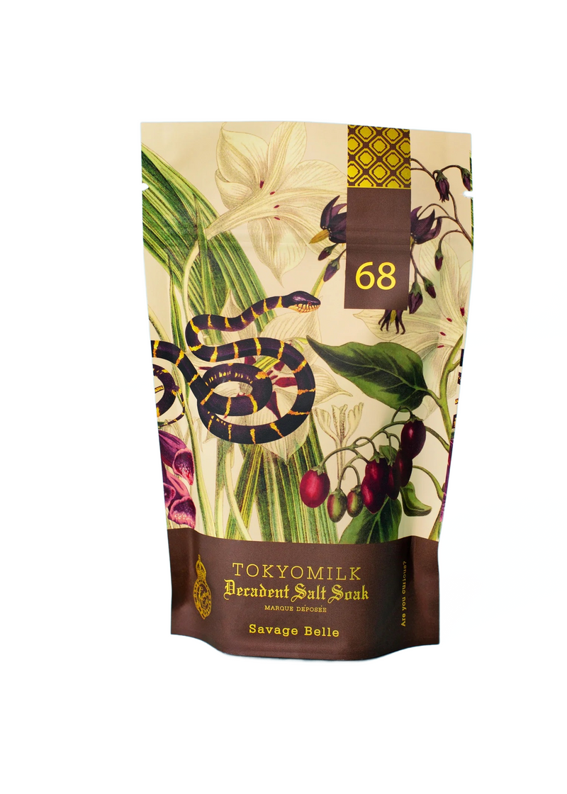 A decorative Margot Elena TokyoMilk Savage Belle Salt Soak package adorned with a floral and snake design, prominently displaying the product's name and the number 68.