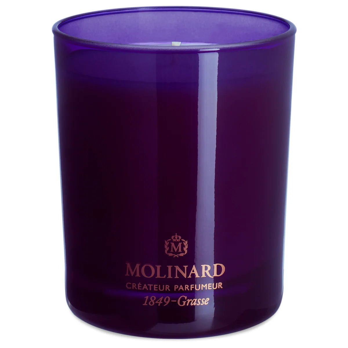 The Molinard Tuberose Candle features a purple glass holder, white wax, and gold "Molinard Créateur Parfumeur 1849 – Grasse" label. Part of the Molinard Home Collection, it brings elegant luxury fragrance to your home.
