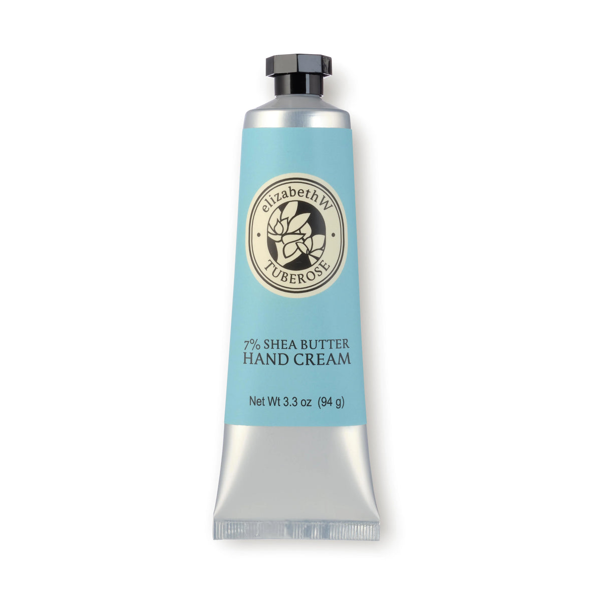 A tube of elizabeth W Botanist's Scent Lab Tuberose Hand Cream, featuring a blue and silver design, is enriched with 7% shea butter and botanical extracts. It is labeled with the brand "elizabeth W" and comes with a black cap. The tube stands upright against a white background, weighing 3.3 oz (94 g).