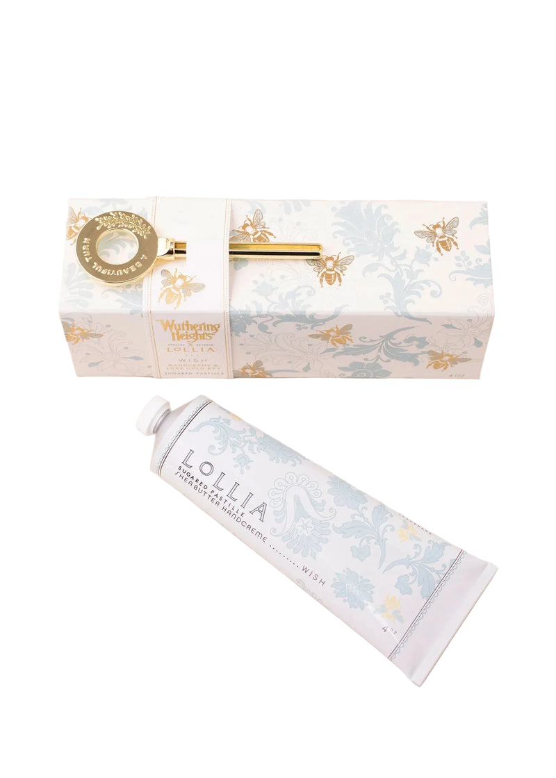 A floral-patterned box with gold accents holds a gold-handled key, while Margot Elena's Lollia "WUTHERING HEIGHTS" Wish Handcreme sits in front in its pastel blue and white tube.