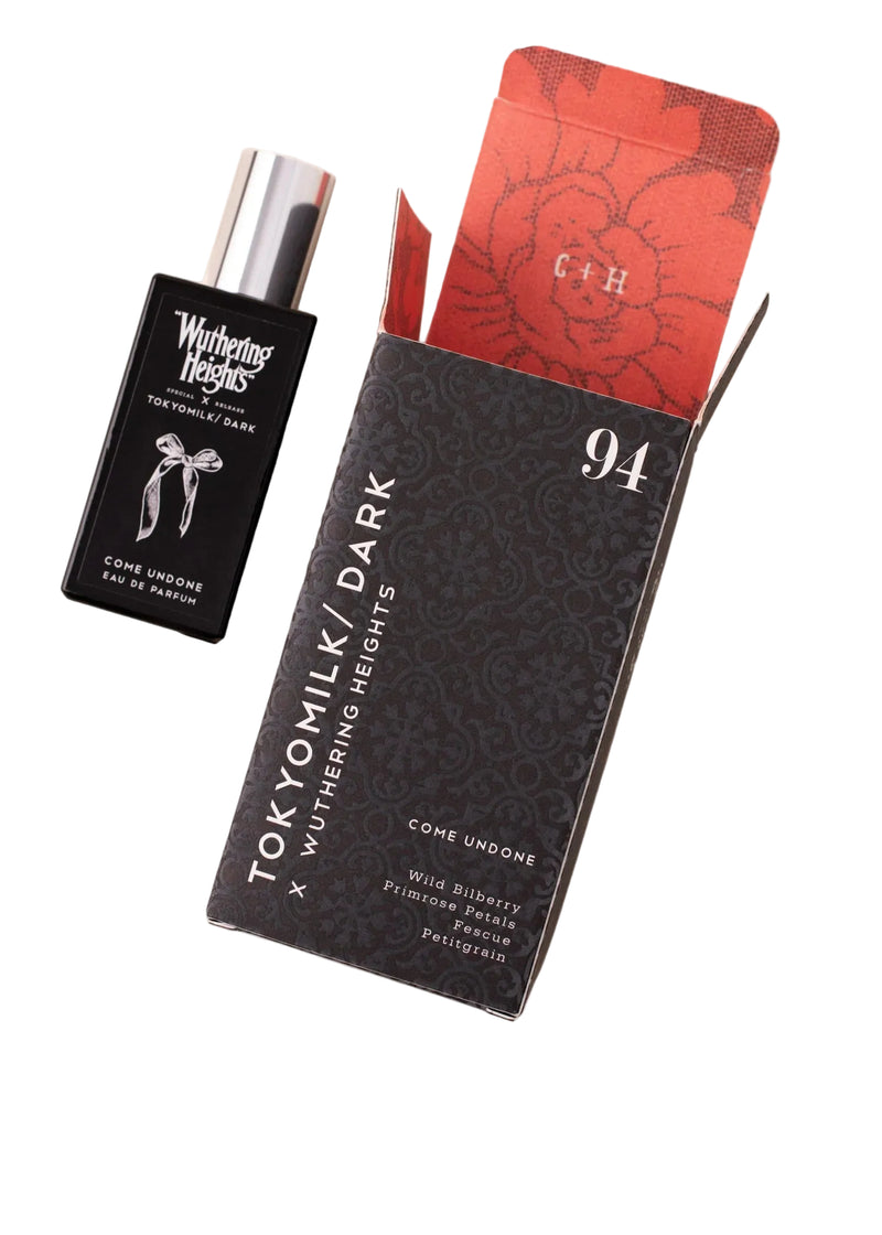 A rectangular black perfume bottle and matching box labeled "TokyoMilk Dark 'WUTHERING HEIGHTS' Come Undone Eau De Parfum" by Margot Elena, with red floral lining and the number 94.