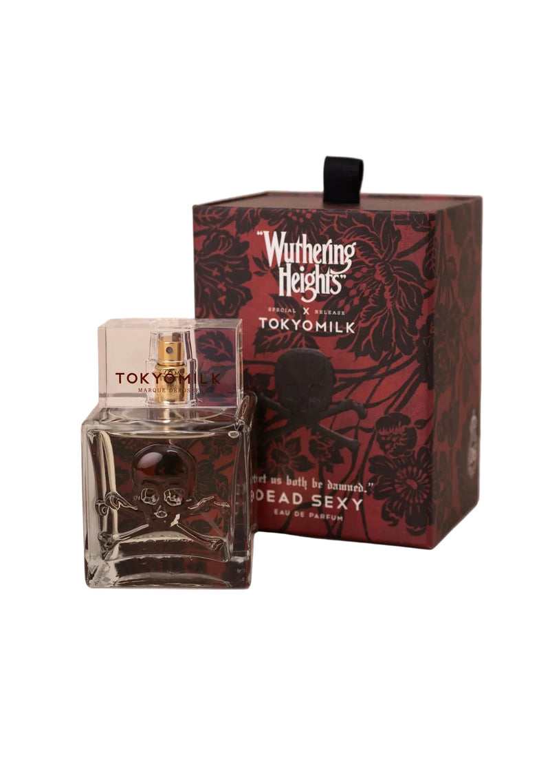 A clear TokyoMilk "WUTHERING HEIGHTS" Dead Sexy Eau de Parfum bottle by Margot Elena stands before a special-release box featuring floral and skull designs, with fragrance notes of vanilla and exotic wood.