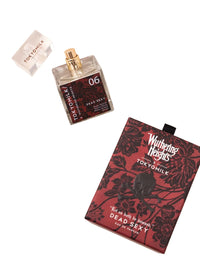 The uncapped TokyoMilk "WUTHERING HEIGHTS" Dead Sexy Eau de Parfum by Margot Elena sits next to its maroon and black floral box, featuring special-release notes of vanilla and exotic wood.