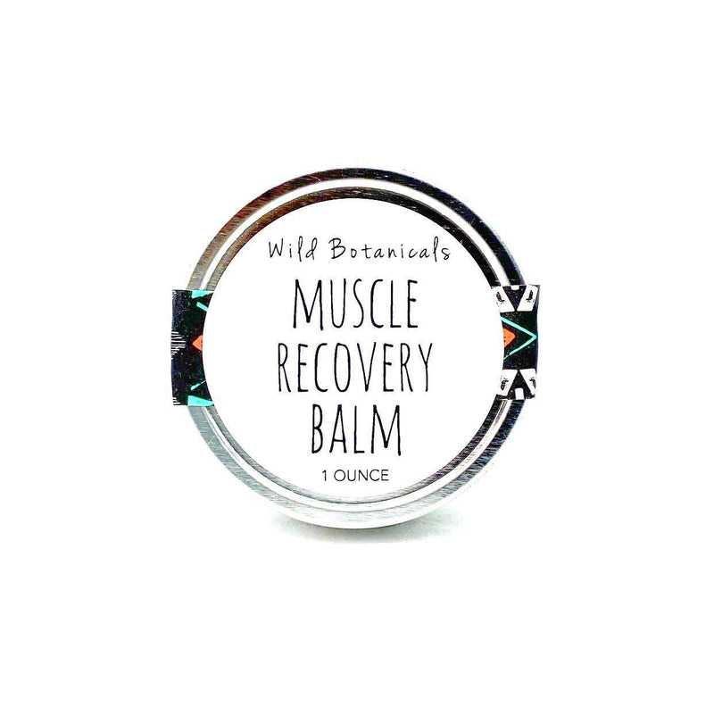 A tin of Wild Botanicals muscle recovery balm, labeled clearly in black type on a white background, 1 ounce size, with a patterned design on the edges.