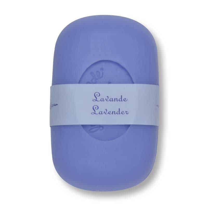 A single bar of La Lavande Lavender Curved Bar Soap wrapped with a label that reads "lavande lavender". The soap is oval-shaped and solid purple in color, presented on a plain white.