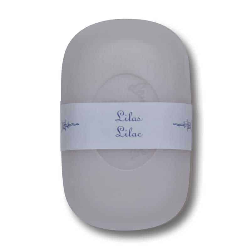 Gray oval-shaped La Lavande Curved Bar Soap - Lilac - 100gm with a white paper label around the middle that reads "lilas lilac" in cursive, accented with small lilac illustrations.