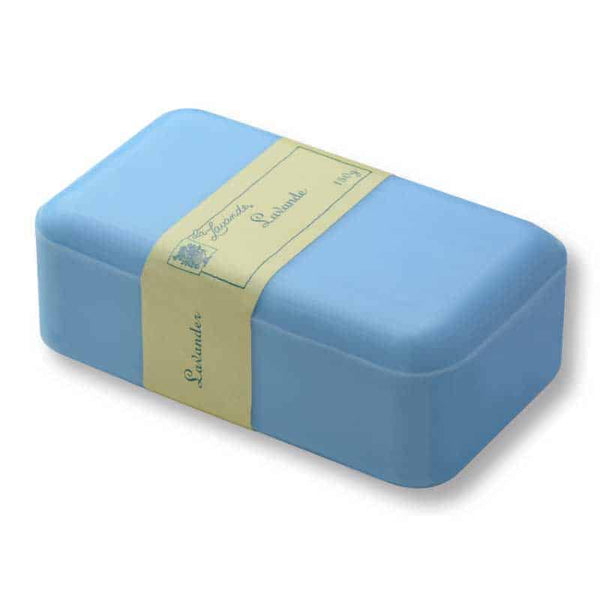 A light blue bar of La Lavande Joie de Vivre Lavender Soap wrapped in a beige paper label, inscribed with elegant cursive handwriting, isolated on a white background.