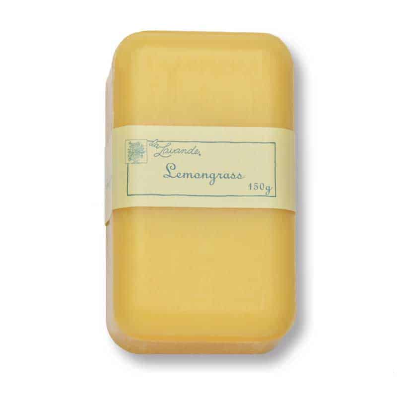 A bar of La Lavande Joie de Vivre Lemongrass Soap in minimalist packaging on a neutral background, showing a light yellow color and a clearly labeled front.