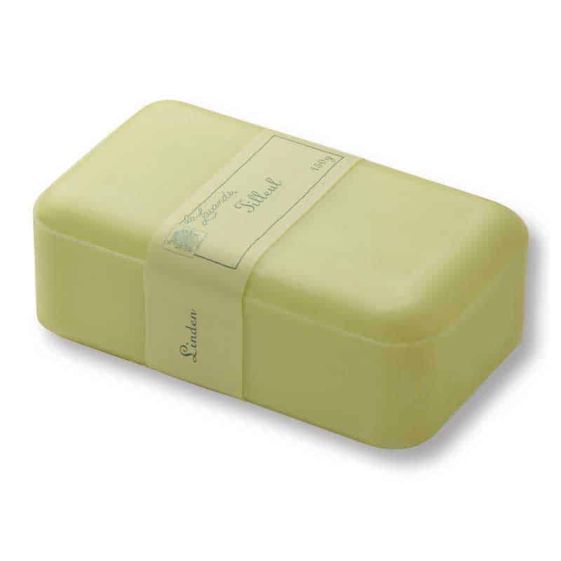 A pale yellow, rectangular La Lavande Joie de Vivre Linden (Tilleul) soap bar with a vintage-style label that includes cursive writing, isolated on a white background.