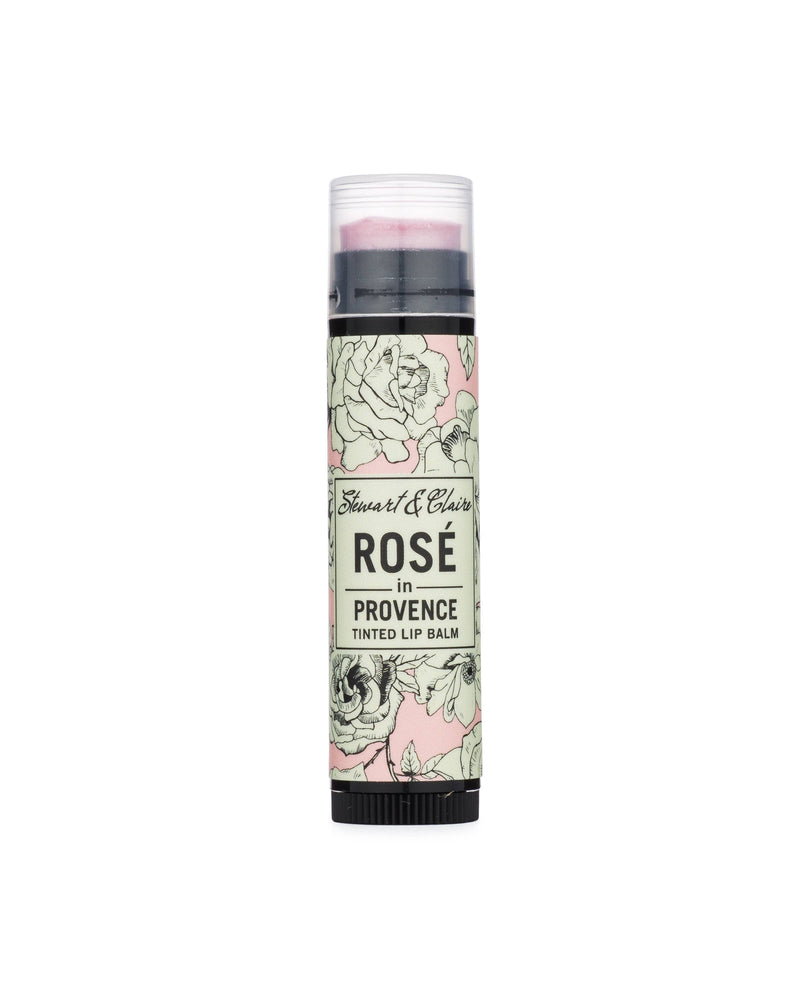 A tube of "Stewart & Claire - Rosé In Provence tinted balm" by Stewart & Claire featuring a floral design with pink and green roses on a light background.