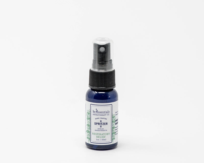 A small bottle of BC Essentials Respiratory Relief Spritzer - 1 oz against a white background. The label is green with white text and a hint of lavender illustration.