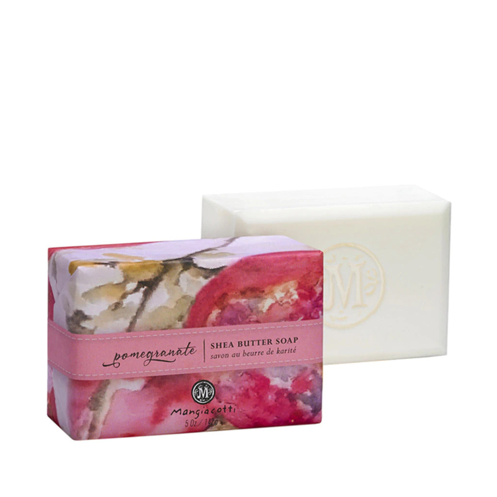 A Mangiacotti Pomegranate Shea Butter Bar Soap, triple-milled body bar next to its packaging. The box has a pink watercolor design with the words "pomegranate" and "Mangiacotti".