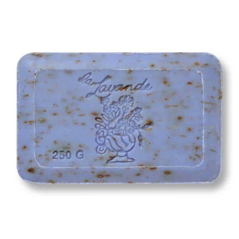 A bar of La Lavande Lavender Flower Soap with visible exfoliating lavender buds, labeled "la lavande" and weighing 200 grams. The soap has a faded blue color with a floral motif.