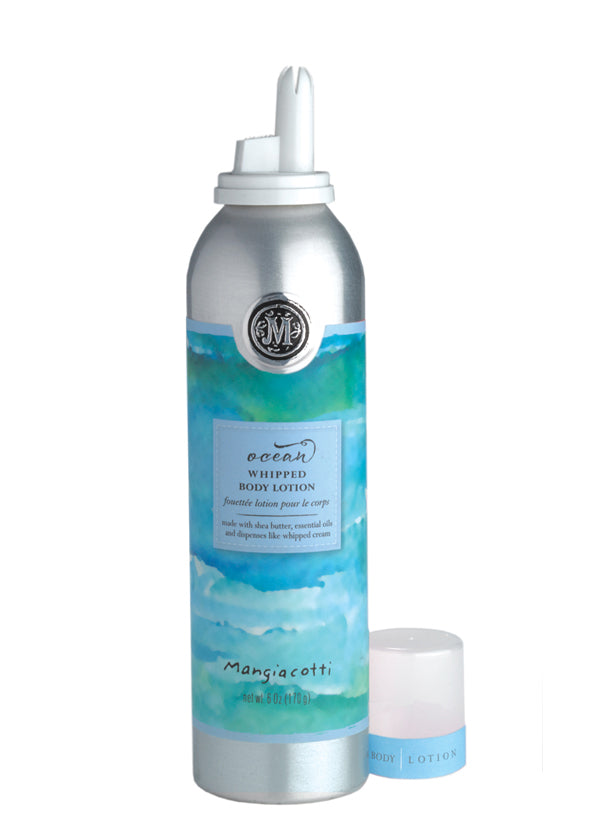 A silver bottle of Mangiacotti Ocean Whipped Body Lotion with a white cap on and a small open jar beside it, set against a white background. The bottle features a blue and turquoise watercolor design.