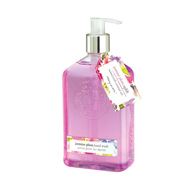 A clear pump bottle of Mangiacotti Jasmine Plum Liquid Hand Wash with pink liquid. The label and a decorative tag with a floral design are attached to the neck of the bottle. Now formulated with essential oils.