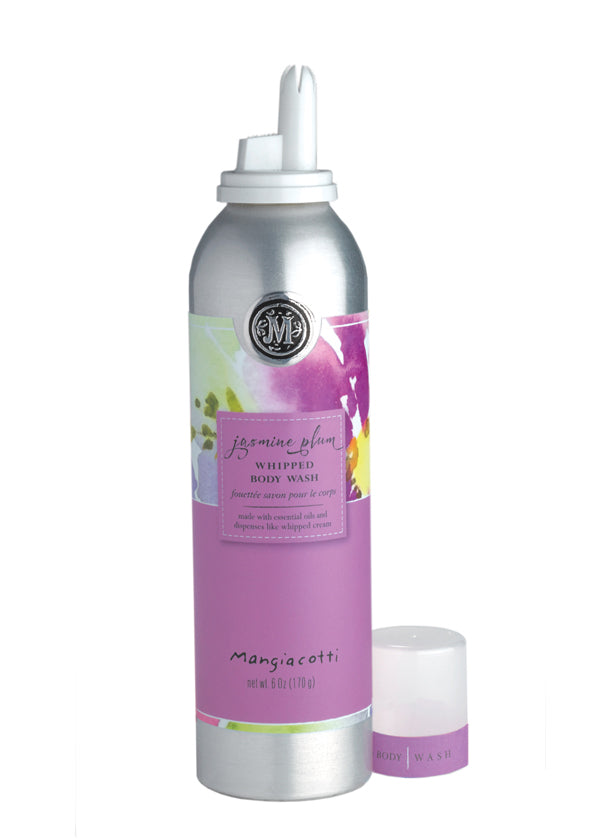 A silver canister of Mangiacotti Jasmine Plum Whipped Body Wash with an attached purple label and a white nozzle, accompanied by a small white jar of the same product. Both display floral graphics.