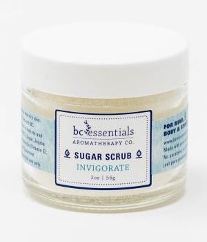 A jar of BC Essentials - Invigorate Sugar Scrub labeled "invigorate" for body use, sized at 2 oz. The product is presented on a white background.