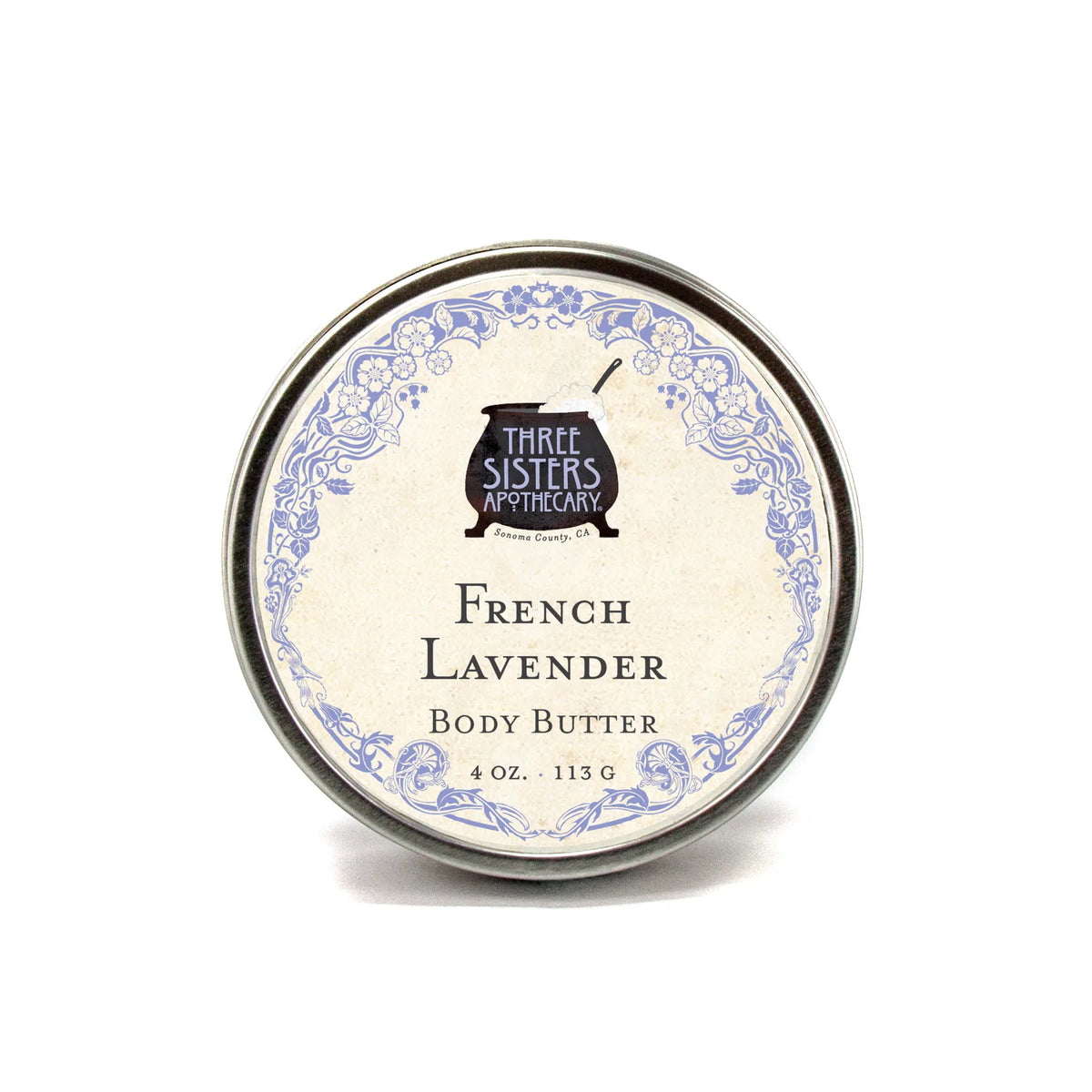 A round tin of Three Sisters Apothecary French Lavender Body Butter with a vintage-style label featuring floral designs, displayed against a plain white background.