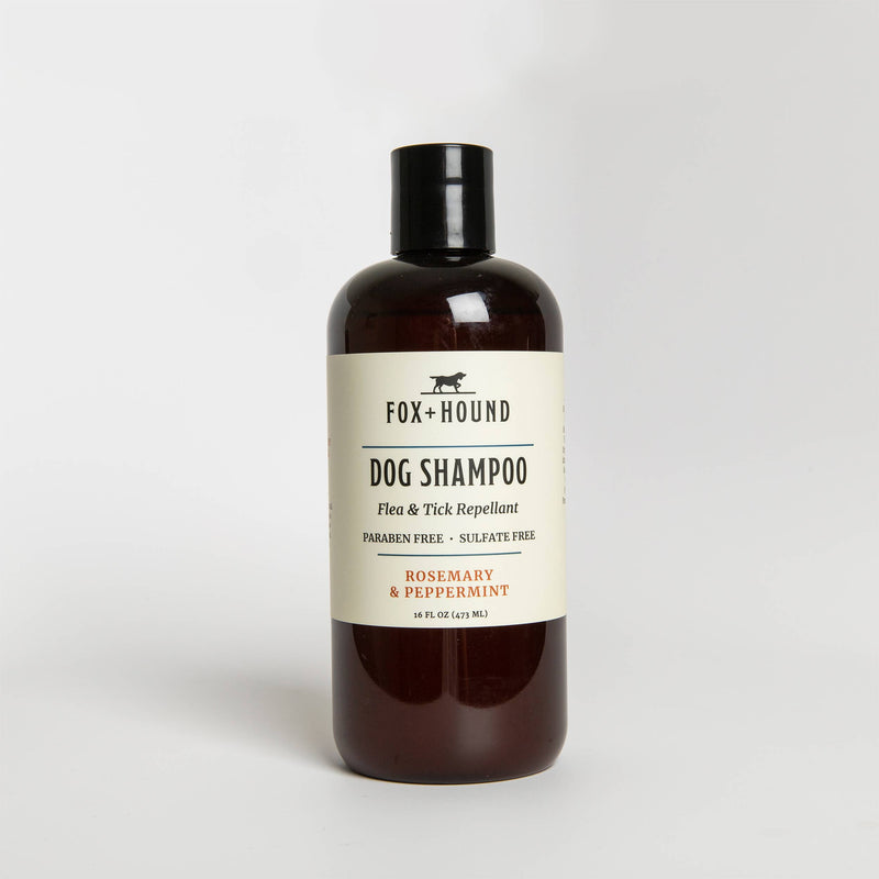 A bottle of Fox + Hound Rosemary Peppermint Dog Shampoo + Conditioner Repels Fleas, labeled as paraben-free and sulfate-free, positioned against a plain white background.