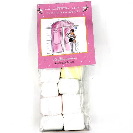 A pack of Senteurs de France traditional marshmallow candy jewelry featuring pastel-colored, pillow-shaped sweets in a transparent wrapper, with an illustration of a girl in a pink Parisian setting on the label.