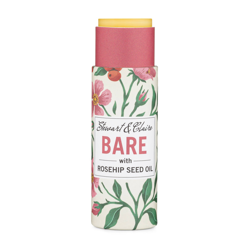 A floral designed skincare product bottle labeled "Stewart & Claire Bare Unscented Lip Balm (with new packaging)," featuring red flowers and green leaves on a white background, now uses eco-friendly packaging.