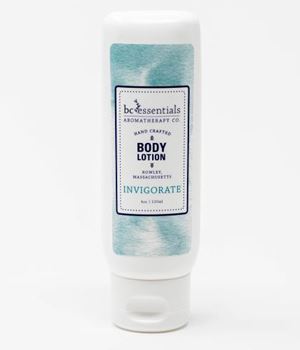 A bottle of BC Essentials - Invigorate Body Lotion - 4oz, made with all natural ingredients, labeled "invigorate" with a white and aqua blue design, standing upright against a white background.