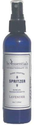 Blue bottle of BC Essentials Lavender Spritzer body mist, labeled "hand crafted" and "indulge, refresh, relax," in a clear and simple font.