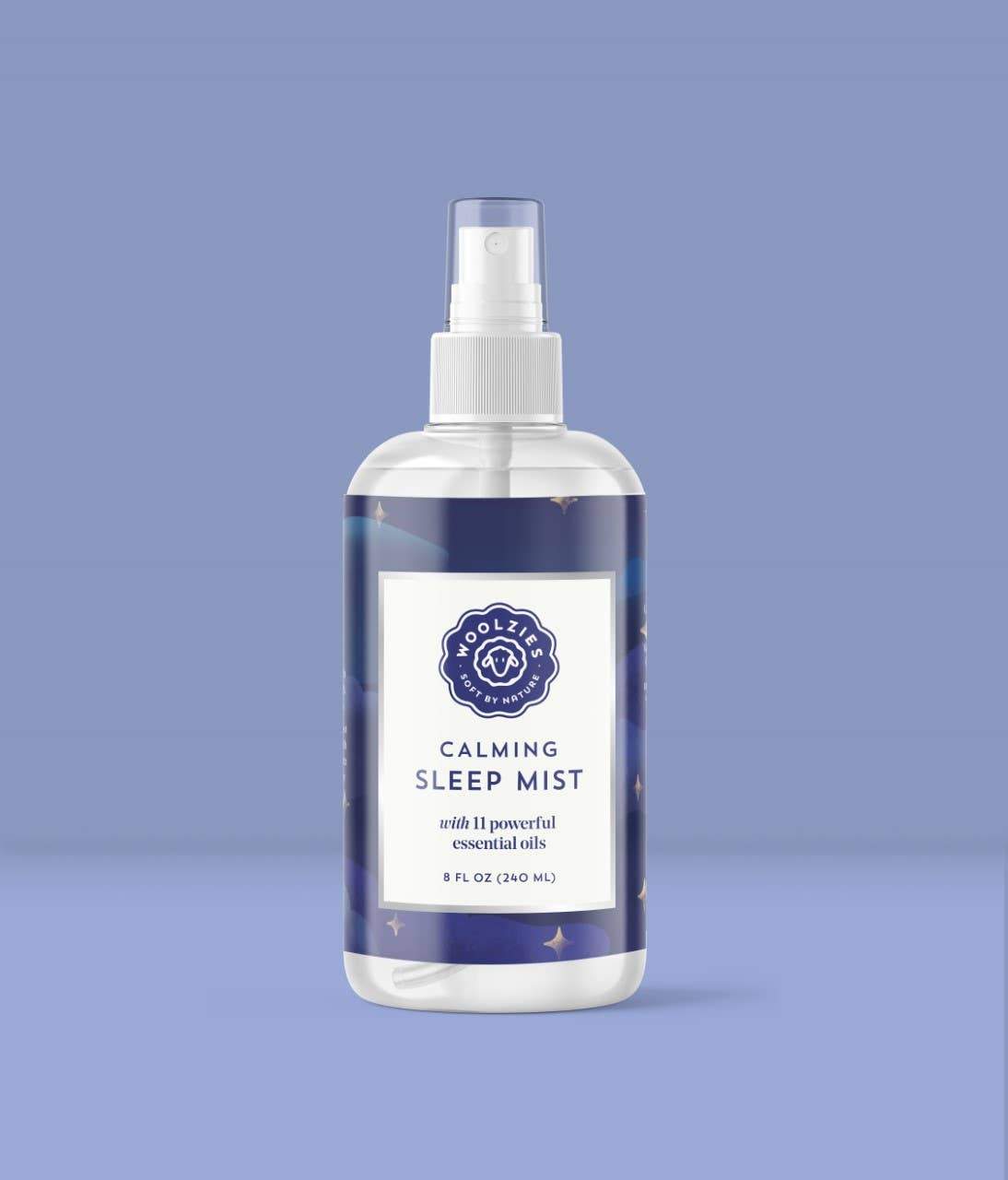 A transparent spray bottle labeled "Woolzies Calming Sleep Mist" with calming natural oils, displayed against a solid light blue background.
