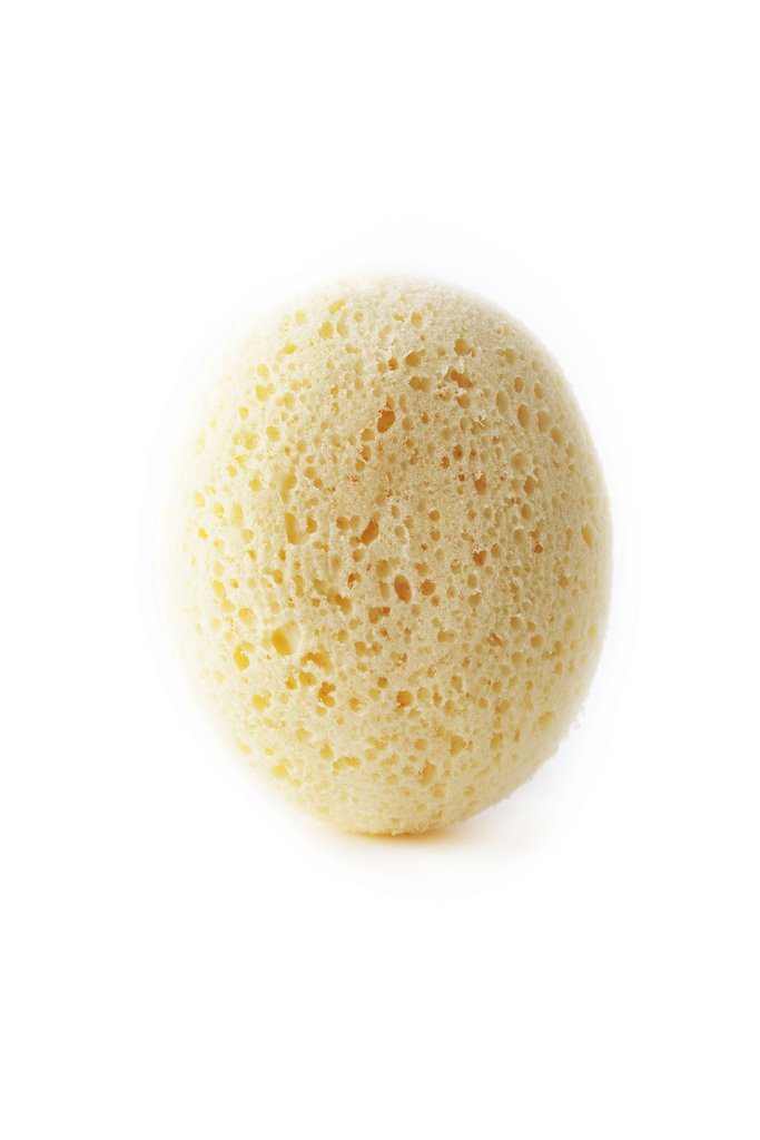 A Andrée Jardin Tradition Pebble Sponge with an ergonomic pebble shape and porous texture, isolated on a white background.