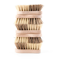 A stack of four Andrée Jardin Tradition Vegetable Brushes with stiff, mixed vegetable fibers, isolated on a white background.