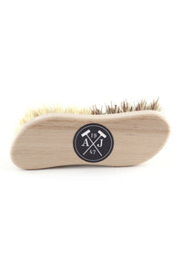 A waxed French beech wood shoe brush with natural bristles, featuring a black circular logo with "Andrée Jardin" and “47” on a white background, isolated on a white backdrop.