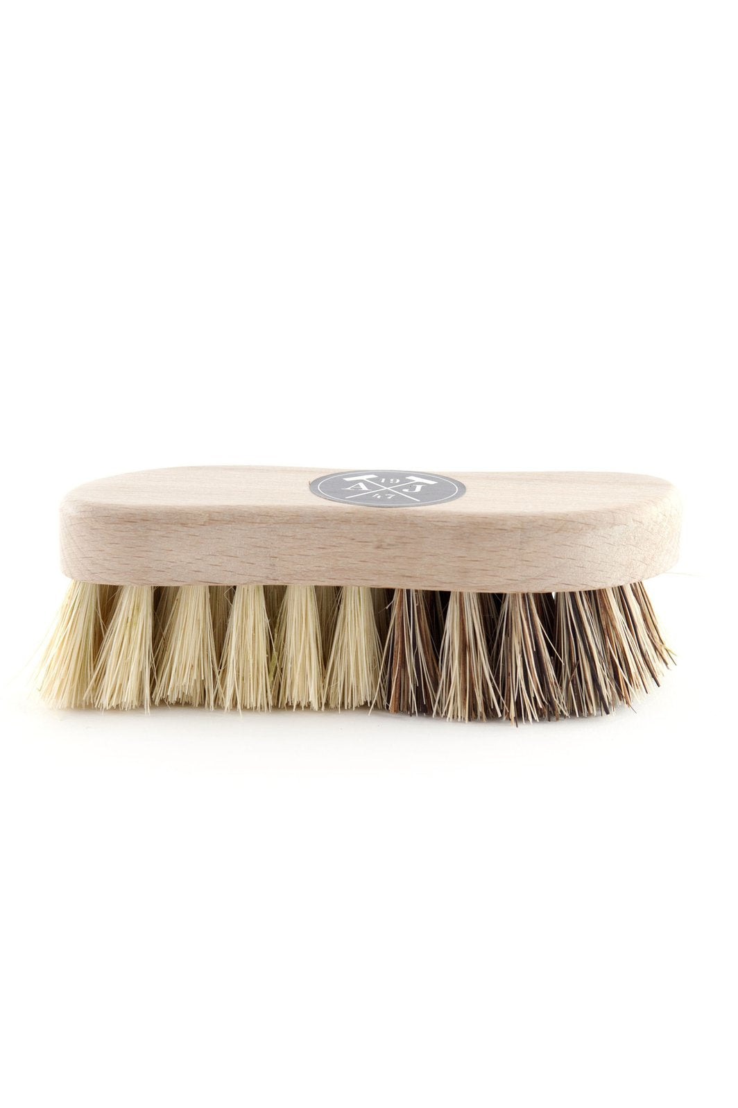 A wooden Andrée Jardin Tradition Vegetable Brush with stiff, natural bristles made from mixed vegetable fibers on a white background. The brush features a simple, oval design with a small, circular logo centered on the top.