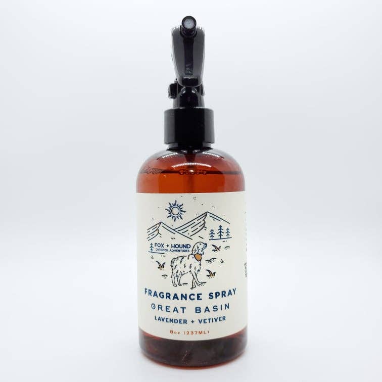 A glass bottle of Fox + Hound Great Basin Spray Cologne For Dogs - National Park Series labeled "Great Basin National Park lavender & vetiver" with a black dropper, featuring a minimalist label design with mountain, sun.