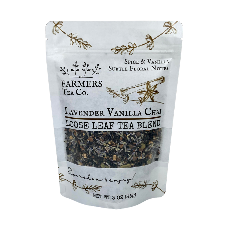 A package of FARMERS Lavender Co. - Lavender Vanilla Chai Tea, a loose-leaf blend, displaying its contents through a transparent window. Decorations include floral motifs and elegant text.